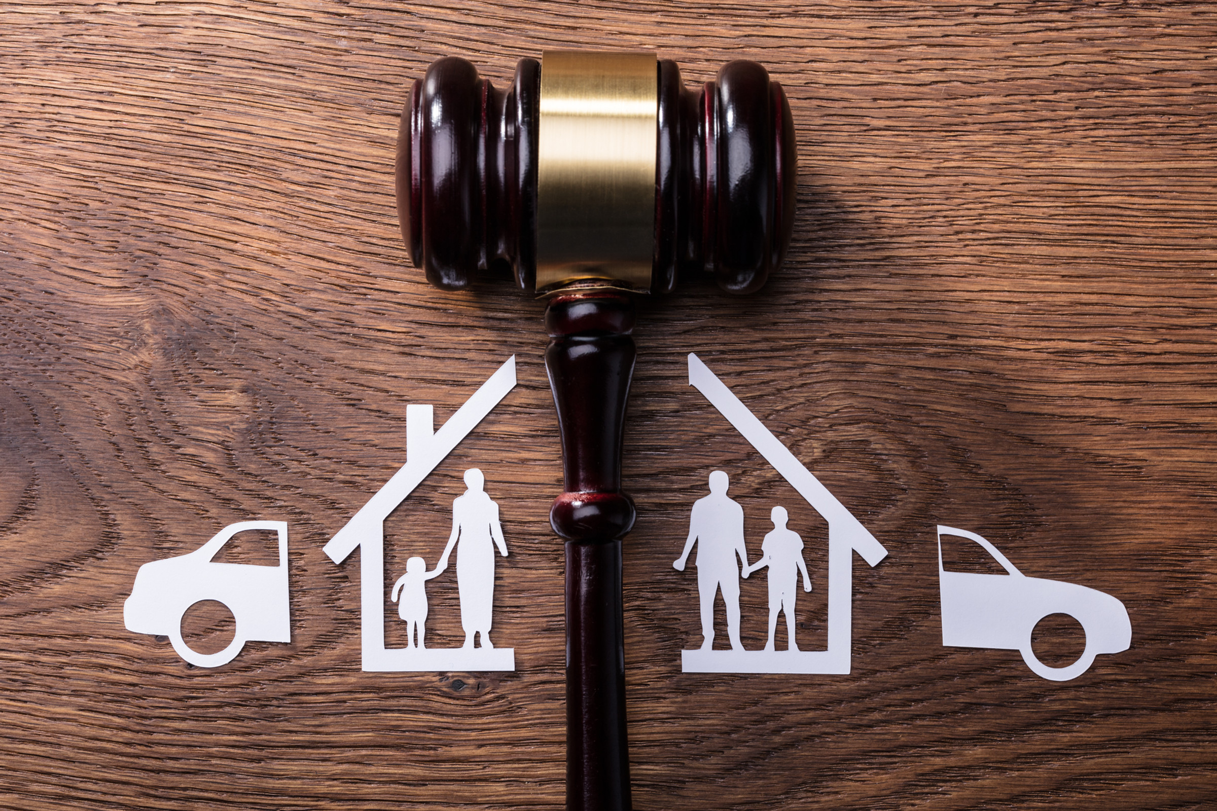 A judge's gavel splitting a house and family in half