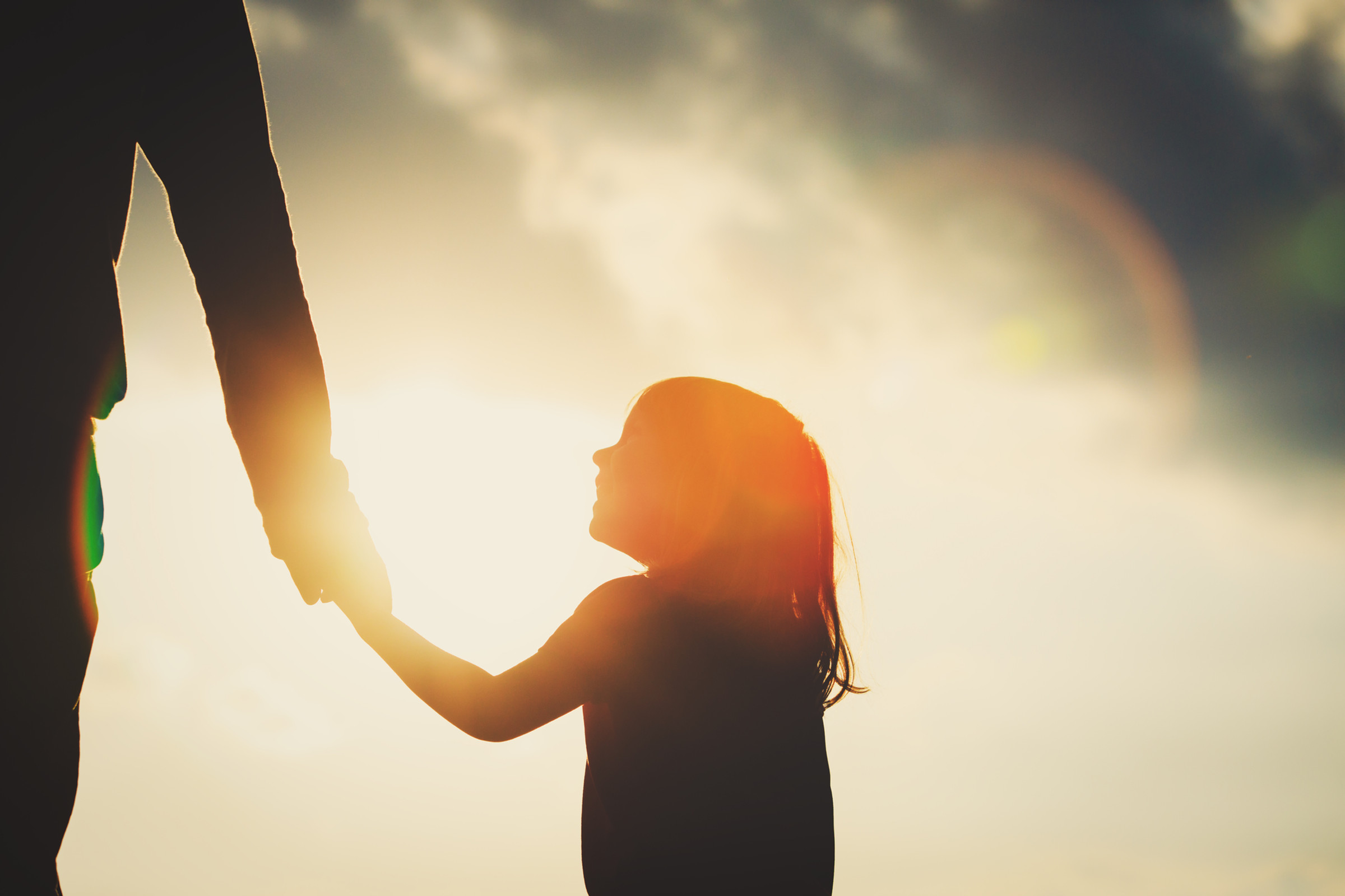 A child holding an adult's hand