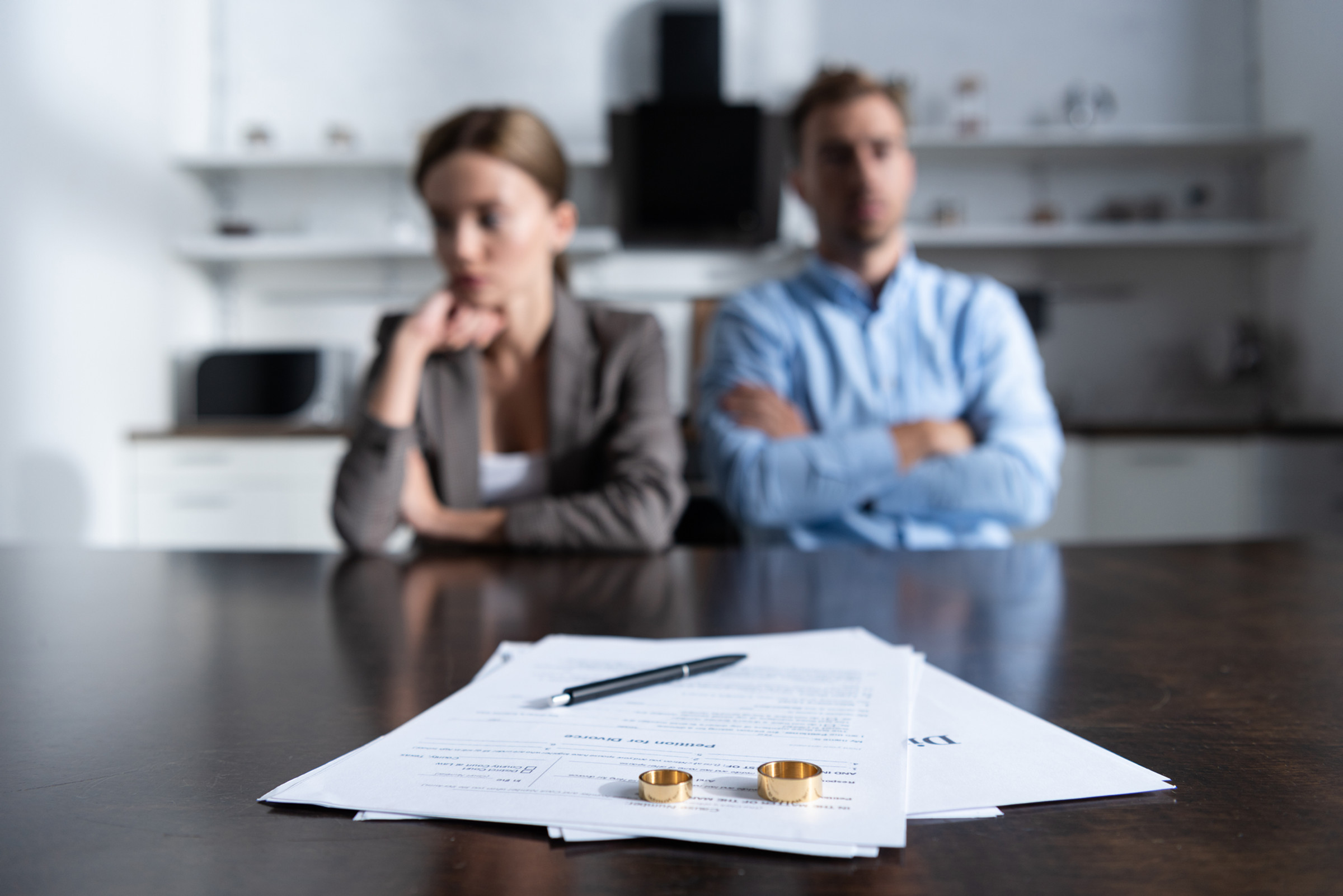 A man and a woman with divorce paperwork in front of them