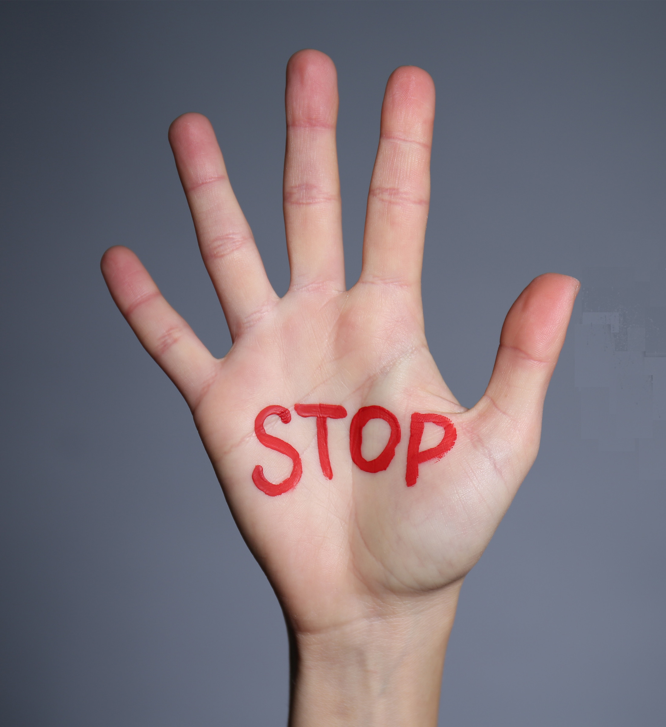 A stop sign drawn on a raised hand