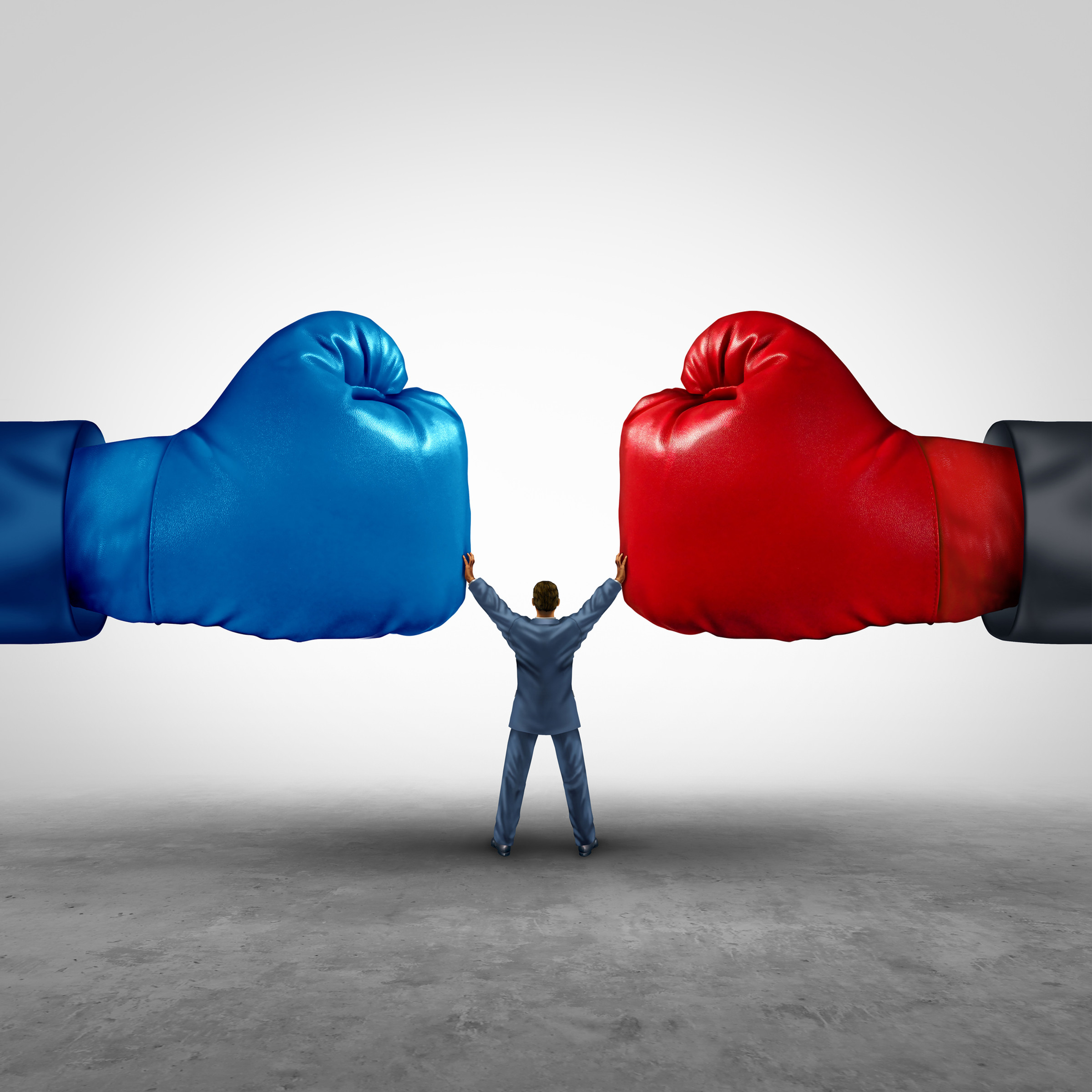 A person standing between two giant boxing gloves, keeping them from hitting each other